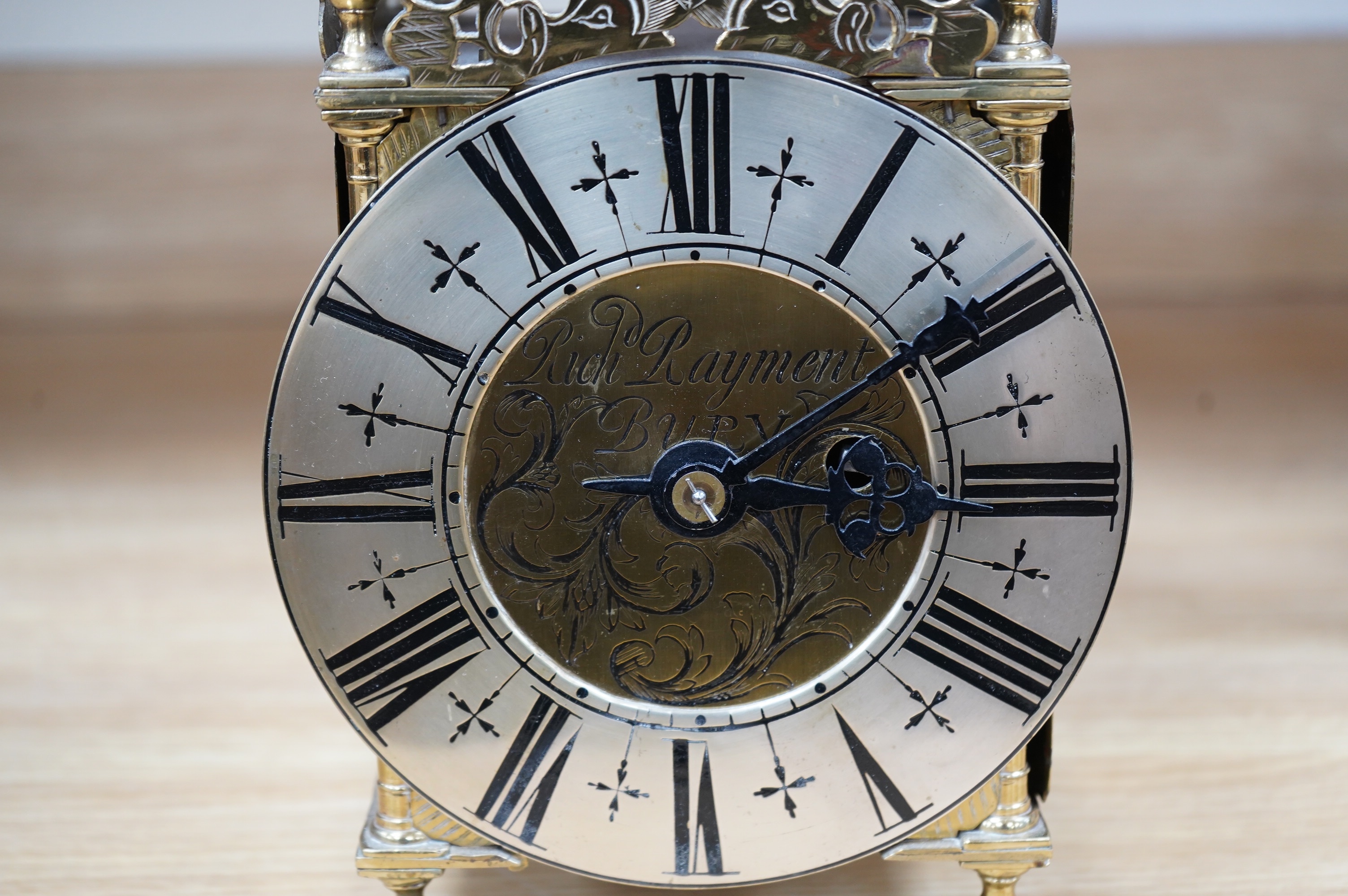 Manner of Richard Rayment of Bury. A Victorian 17th century style lantern clock, in traditional brass case with silvered Roman dial and eight day single fusee movement striking on a bell, 17cm wide, 14.5cm deep, 38cm hig